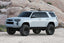 Fabtech 10-15 Toyota 4Runner 4WD 6in Lift System - Component Box 2 with offroad wheels and tires