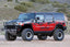 Fabtech 03-08 Hummer H2 4WD 6in Performance System - Component Box 1 - Black on rugged terrain with offroad wheels