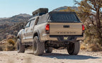 MagnaFlow Stainless Overland Cat-Back Exhaust 16-21 Toyota Tacoma with offroad tires in a desert setting.