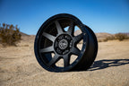 ICON Rebound 17x8.5 6x5.5 0mm Offset 4.75in BS 106.1mm Bore Double Black Wheel on sandy terrain