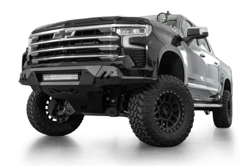Addictive Desert Designs2022+ Chevrolet Silverado 1500 Black Label Front Bumper with offroad wheels and lighting.