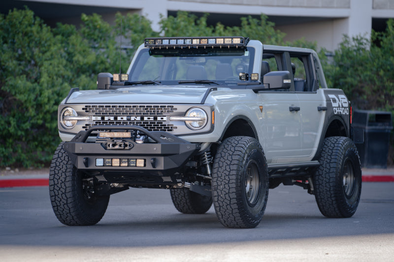 DV8 Offroad 21-22 Ford Bronco Front Lower Control Arm Skid Plate on customized offroad vehicle.