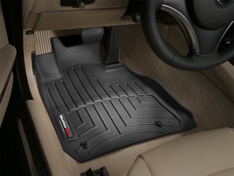 WeatherTech 06-12 BMW 3-Series Front FloorLiner - Black in vehicle interior.