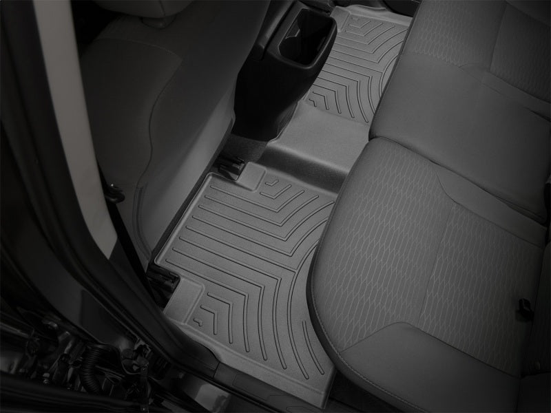 WeatherTech 16+ Toyota Tacoma Double Cab Rear FloorLiner - Black in a truck interior for ultimate protection.