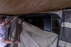 Person using ARB Dlxe Awn Room W/Flr 2.5M98Lg 2500X2500mm 98X98In for vehicle access