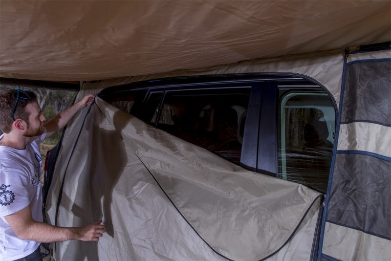 Person using ARB Dlxe Awn Room W/Flr 2.5M98Lg 2500X2500mm 98X98In for vehicle access