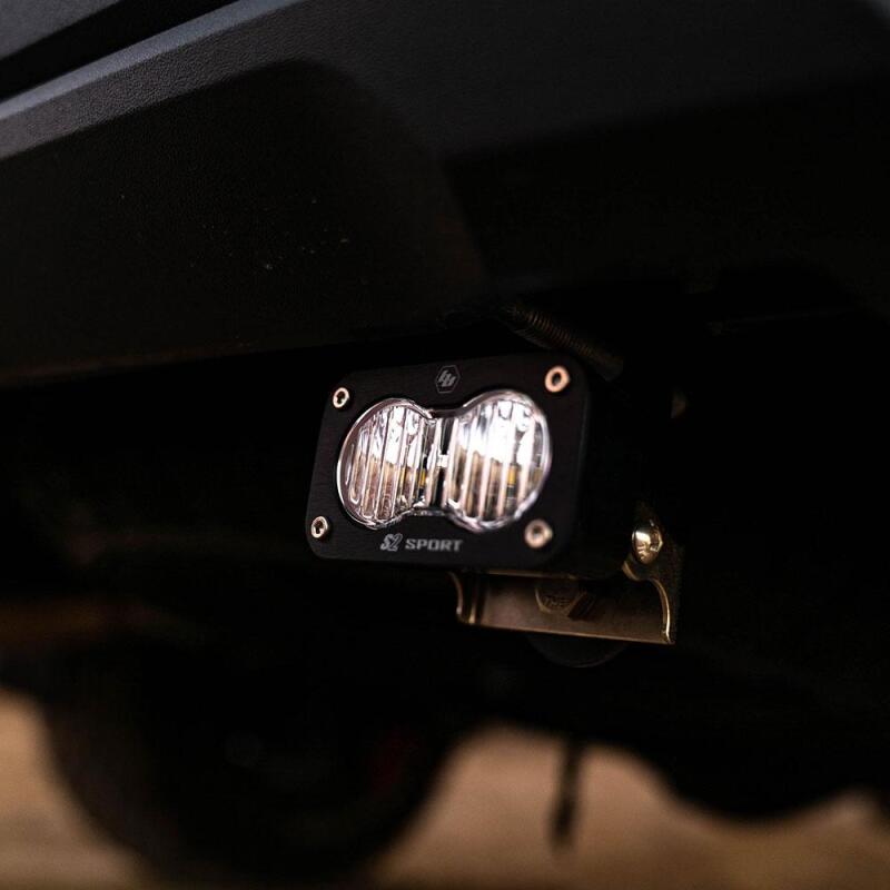 Baja Designs 2024+ Toyota Tacoma S2 Sport Reverse Kit w/ Plug and Play Harness mounted under a truck for offroad lighting.