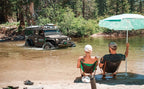 MagnaFlow 12-18 Jeep Wrangler 2.5in Overland Series Cat-Back Exhaust in action near water with offroad enthusiasts.