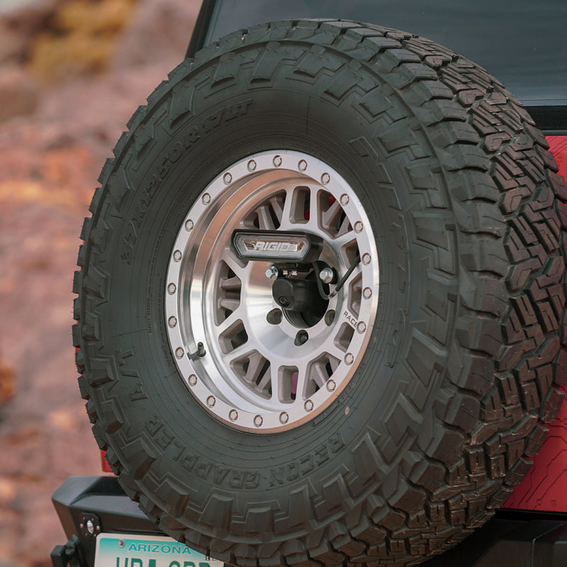 Rigid Industries 2021+ Ford Bronco Rear Chase Pod Light Kit mounted on offroad tire