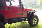 Fishbone Offroad 97-06 Jeep Wrangler TJ Steel Rock Slider - Black Textured Powdercoat on red Jeep