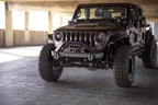 DV8 Offroad 07-23 Jeep Wrangler JK/JL & Gladiator JT FS-15 Series Front Bumper with offroad tires and exterior accessories.