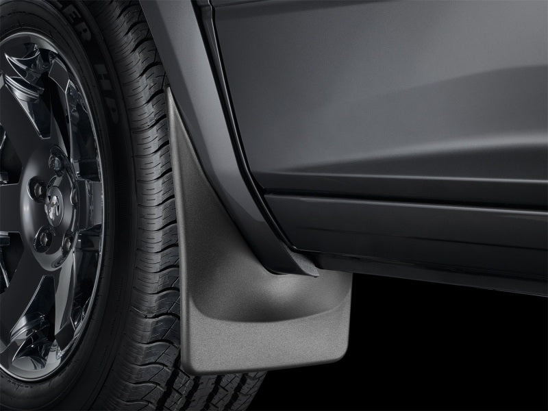 WeatherTech 08-10 Ford F250/F350 No Drill Mudflaps - Black installed on truckwheel, great for offroad and exterior accessories. Main image