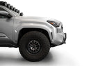 Addictive Desert Designs2024+ Toyota Tacoma Stealth Center Mount Winch Front Bumper w/ Top Hoop on a gray truck with offroad tires.