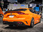 Borla 2018 Kia Stinger 2.0L/3.3L AT RWD/AWD 2.25in Carbon Fiber Tip Kit on orange Stinger at SEMA event.
