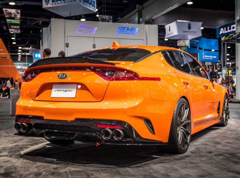 Borla 2018 Kia Stinger 2.0L/3.3L AT RWD/AWD 2.25in Carbon Fiber Tip Kit on orange Stinger at SEMA event.