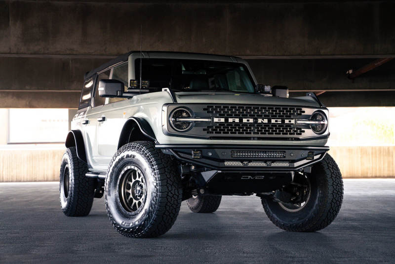 DV8 Offroad 21-22 Ford Bronco Competition Series Front Bumper installed on a lifted Bronco with offroad tires