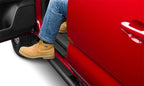 N-Fab Trail Slider Steps 16-20 Toyota Tacoma Crew Cab All Beds - SRW - Textured Black with a person stepping out