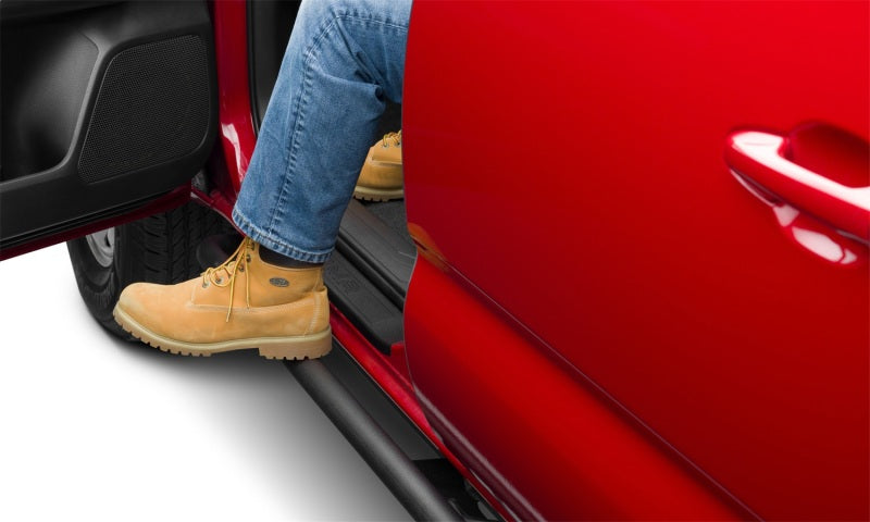 N-Fab Trail Slider Steps 16-20 Toyota Tacoma Crew Cab All Beds - SRW - Textured Black with a person stepping out