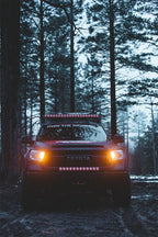 Rigid Industries 20in Adapt Light Bar on Toyota truck in woods