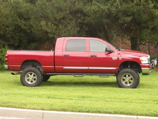 Red lifted truck showcasing offroad parts and accessories.