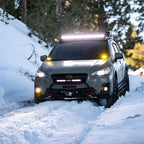 Rigid Industries SR-Series 20in SAE Driving Light Amber on off-road vehicle in snow