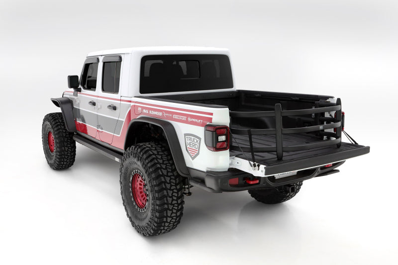 AMP Research 20-22 Jeep Gladiator (Does Not Work w/Tonneau Cvrs) Bedxtender HD Sport - Black on truck with offroad tires.