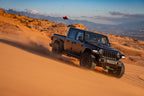 Fox 2019+ Jeep Gladiator JT 2.0 Perf Series 11.2in Smooth Body IFP Rear Shock / 2-3in Lift off-roading in dunes.