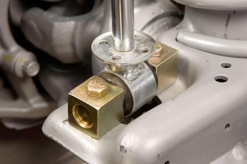 JKS Manufacturing Jeep Wrangler TJ/LJ Lower Shock Bar Pin Eliminator - Front close up on suspension component.