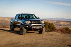 Body Armor 4x4 12-15 Toyota Tacoma HiLine Front Winch Bumper on off-road terrain