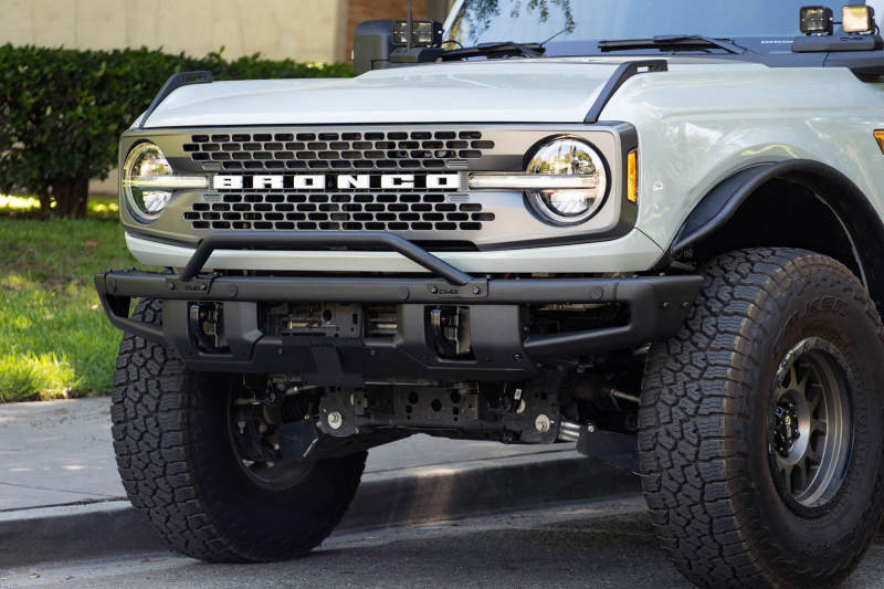 DV8 Offroad 21-22 Ford Bronco Factory Front Bumper Licence Relocation Bracket - Front showcased on a modified Bronco.