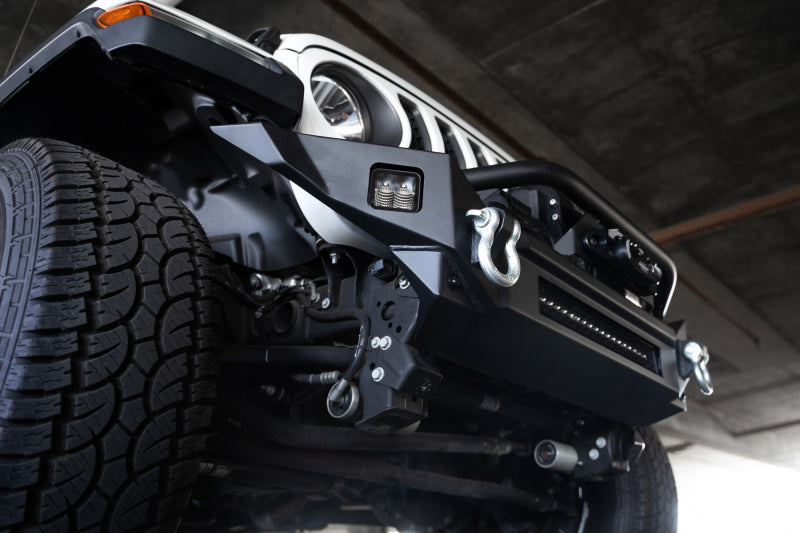 Close-up of DV8 Offroad 18-23 Jeep Wrangler JL / 20-23 Jeep Gladiator JT FS-7 Mid-Width Winch Front Bumper with winch and D-ring mounts.