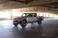 DV8 Offroad 07-23 Jeep Wrangler JK/JL & Gladiator JT FS-1 Series Stubby Front Bumper in parking garage setting.