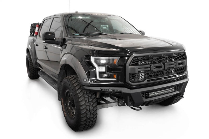 Addictive Desert Designs17-20 Ford F-150 Raptor Phantom Front Bumper on a black truck with offroad wheels.