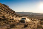 Fox 20+ Jeep JT Gladiator 2.0 Performance Series Remote Reservoir Rear Shock 2-3in Lift on a desert trail in off-road environment