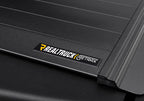 Retrax 09-up Ram 1500 6.5ft Bed / 10-up Short Bed RetraxPRO MX close-up with RealTruck logo