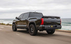 MagnaFlow 22+ Toyota Tundra Street Series 3in Dual Driver Side Rear Cat-Back Exhaust in action on a scenic road.