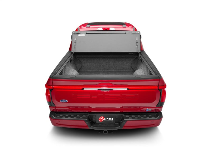 BAK 21-22 Ford F-150 (Incl. 2022 Lightning) BAKFlip MX4 5.7ft Bed Cover - Matte Finish on red truck