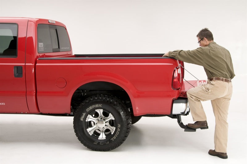 AMP Research 1999-2016 Ford F-250/350/450 BedStep - Black in use on red truck