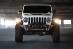 DV8 Offroad 18-23 Jeep Wrangler JL / 20-23 Jeep Gladiator JT FS-7 Mid-Width Winch Front Bumper in parking garage