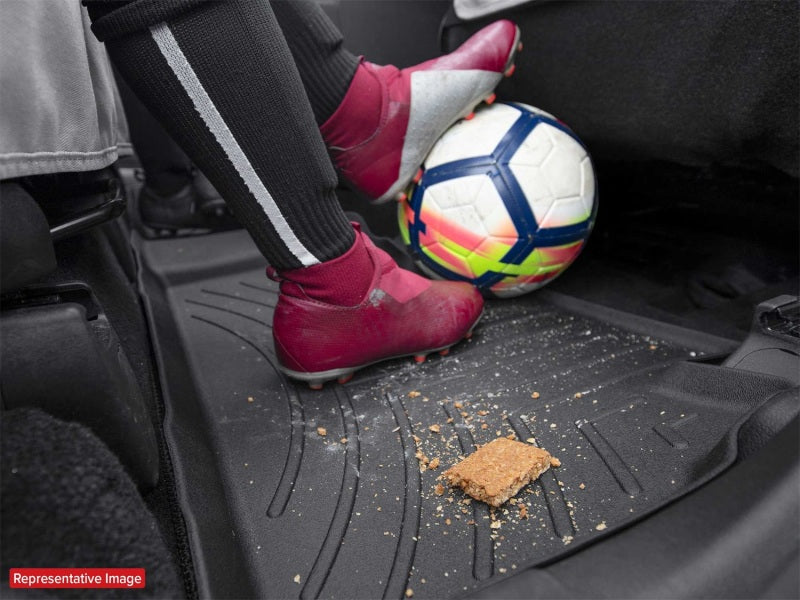 WeatherTech 2019+ RAM 2500/3500 Crew Cab/Mega Cab Front FloorLiner - Black with soccer ball and dirt.