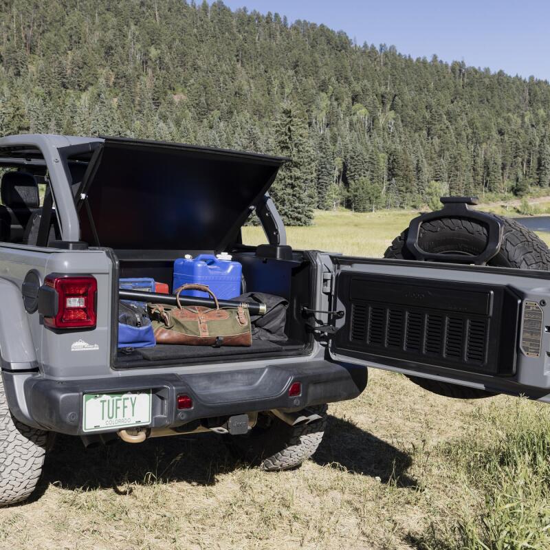 Tuffy Deluxe Enclosure For Jeep Wrangler W/ Subwoofer in rear view with gear organized, ideal for offroad adventures.