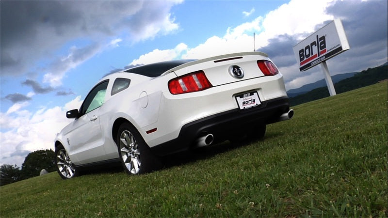 Borla 11-12 Ford Mustang 3.7L AT/MT RWD 2dr ATAK SS Catback Exhaust on grassy field.