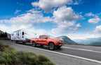 Air Lift Loadlifter 5000 Air Spring Kit 05-23 Toyota Tacoma 2/4WD towing a trailer on a scenic highway