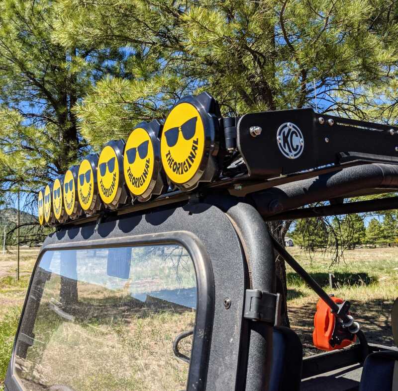 KC HiLiTES 6in. Hard Cover for Gravity Pro6 LED Lights (Single) - Smiley Face- Yellow/Black KC Logo on off-road vehicle roof