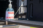 Hand sanitizer bottle on Jeep Wrangler JL tailgate table.