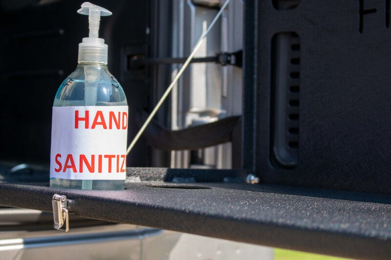 Hand sanitizer bottle on Jeep Wrangler JL tailgate table.