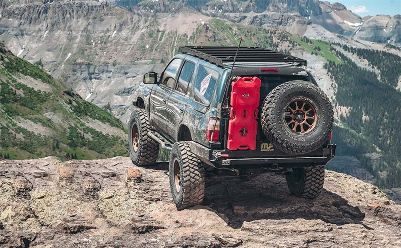 MagnaFlow 98-02 Toyota 4Runner Overland Series Cat Back Performance Exhaust on offroad vehicle with overland gear in scenic mountain view.