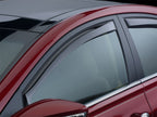 WeatherTech 06-10 Dodge Charger Front Side Window Deflectors - Dark Smoke on a red car.