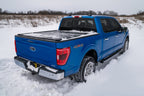 Retrax 21-22 Ford F-150 Super Crew/Super Cab (Incl. 2022 Lightning) 5.5ft Bed RetraxPRO XR on snowy terrain.