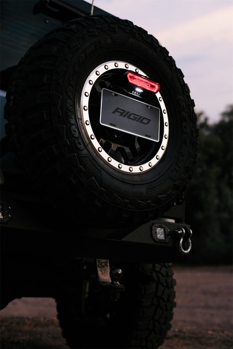 Rigid Industries Chase Tail Light Kit w/ Mounting Bracket - Red on off-road tire, enhancing Jeep exterior accessories.